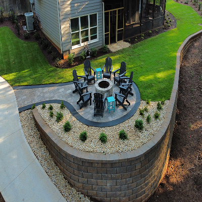 Backyard fire pit area with seating and stone landscaping.
