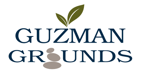 Guzman Grounds logo with leaves and stones.